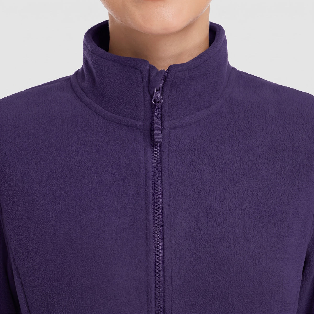 Close-up of the stand collar and zip puller of the women's fleece jacket