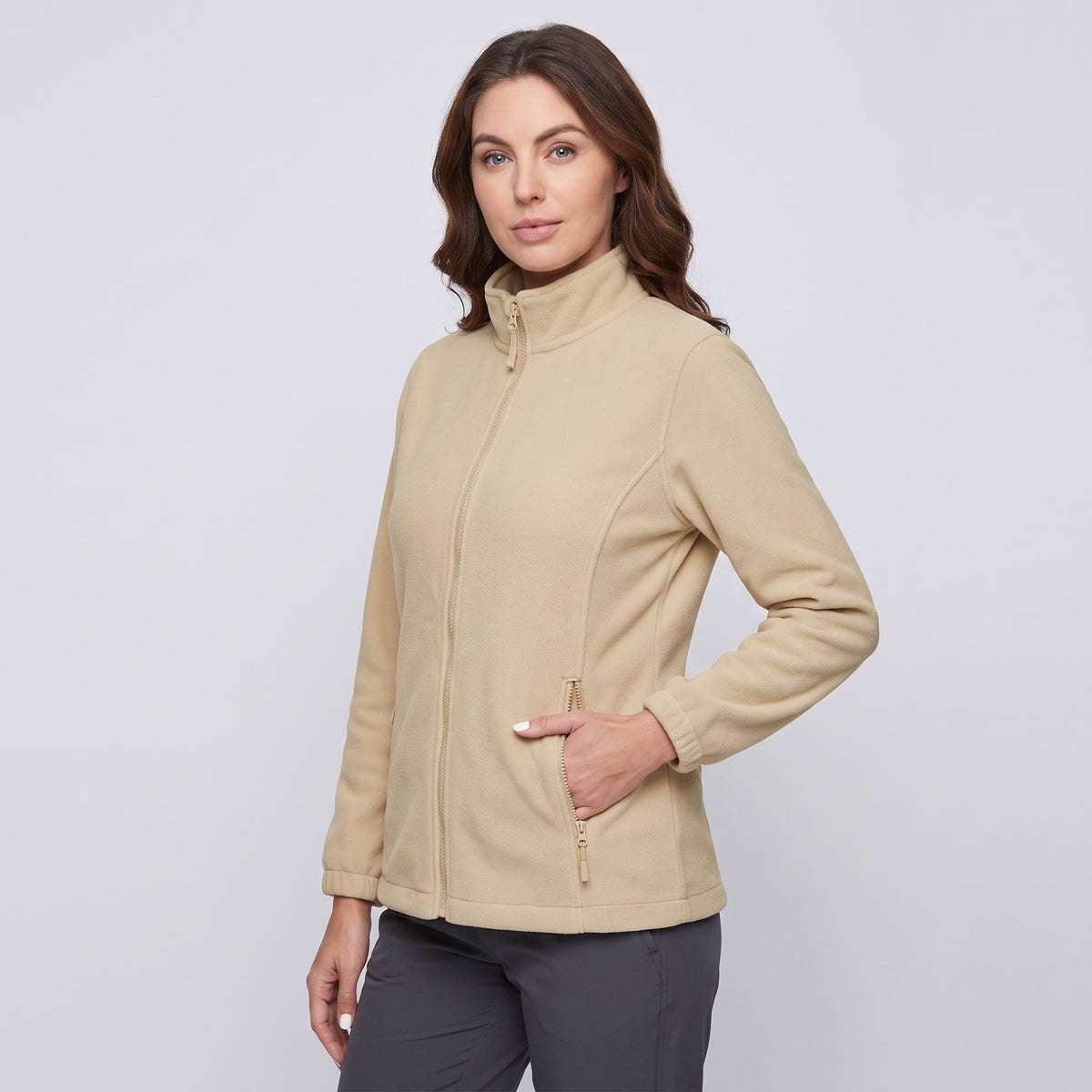 Women's fleece jacket in Beige, three-quarter view with a hand in a zip pocket