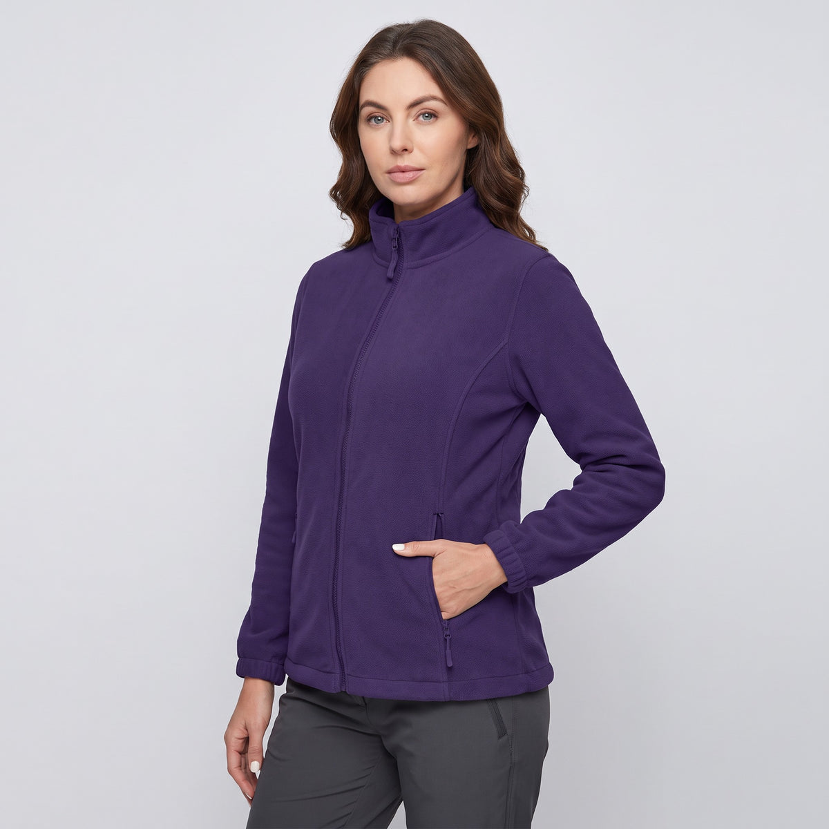 Women's fleece jacket in Dark Purple, three-quarter view with a hand in a zip pocket