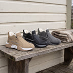 Khaki, Black and Grey men's winter trainers lined up on a porch bench
