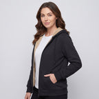Woman in the Black sherpa zip up hoodie, three-quarter side view with a hand in the pocket