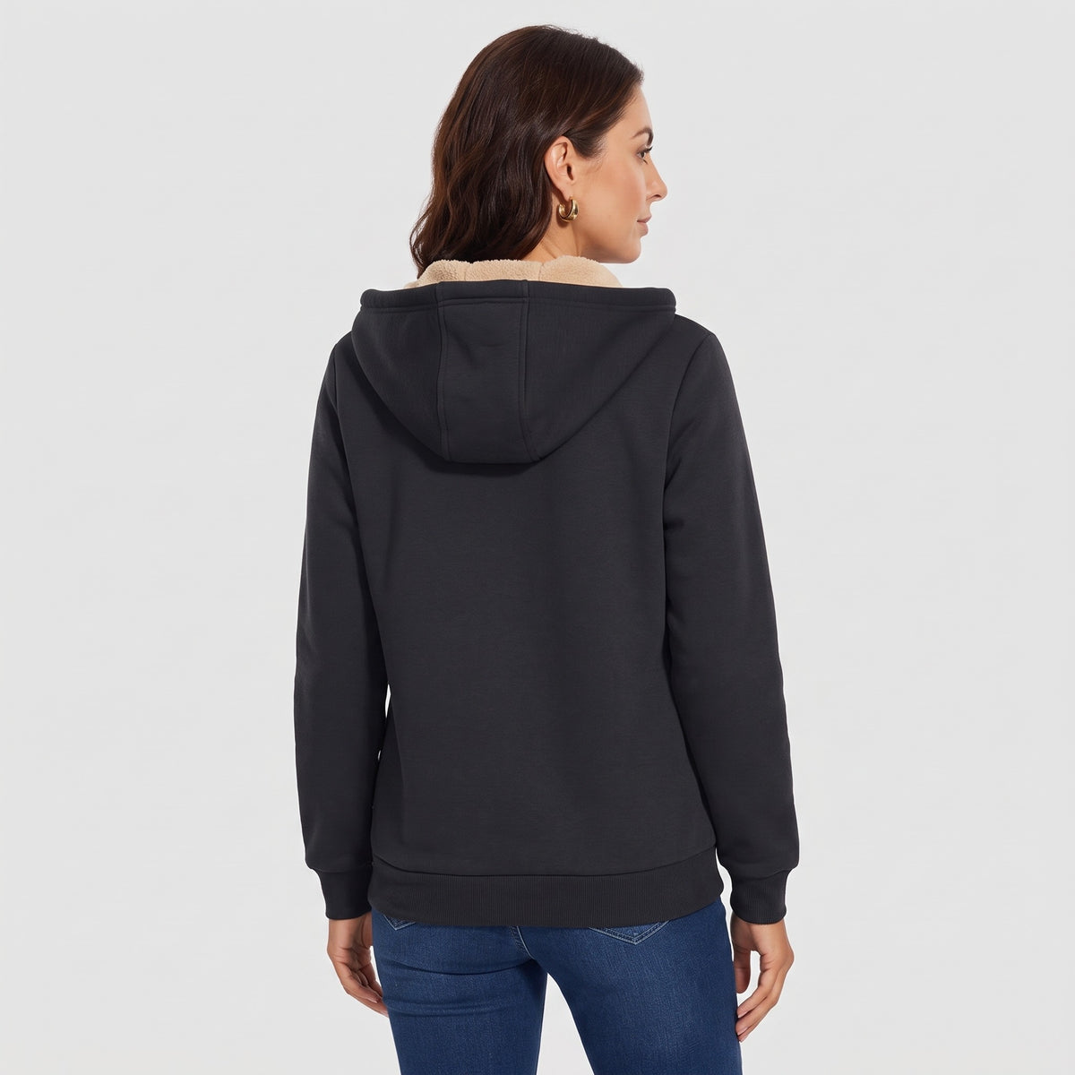 Back view of a woman wearing the Black sherpa lined zip up hoodie