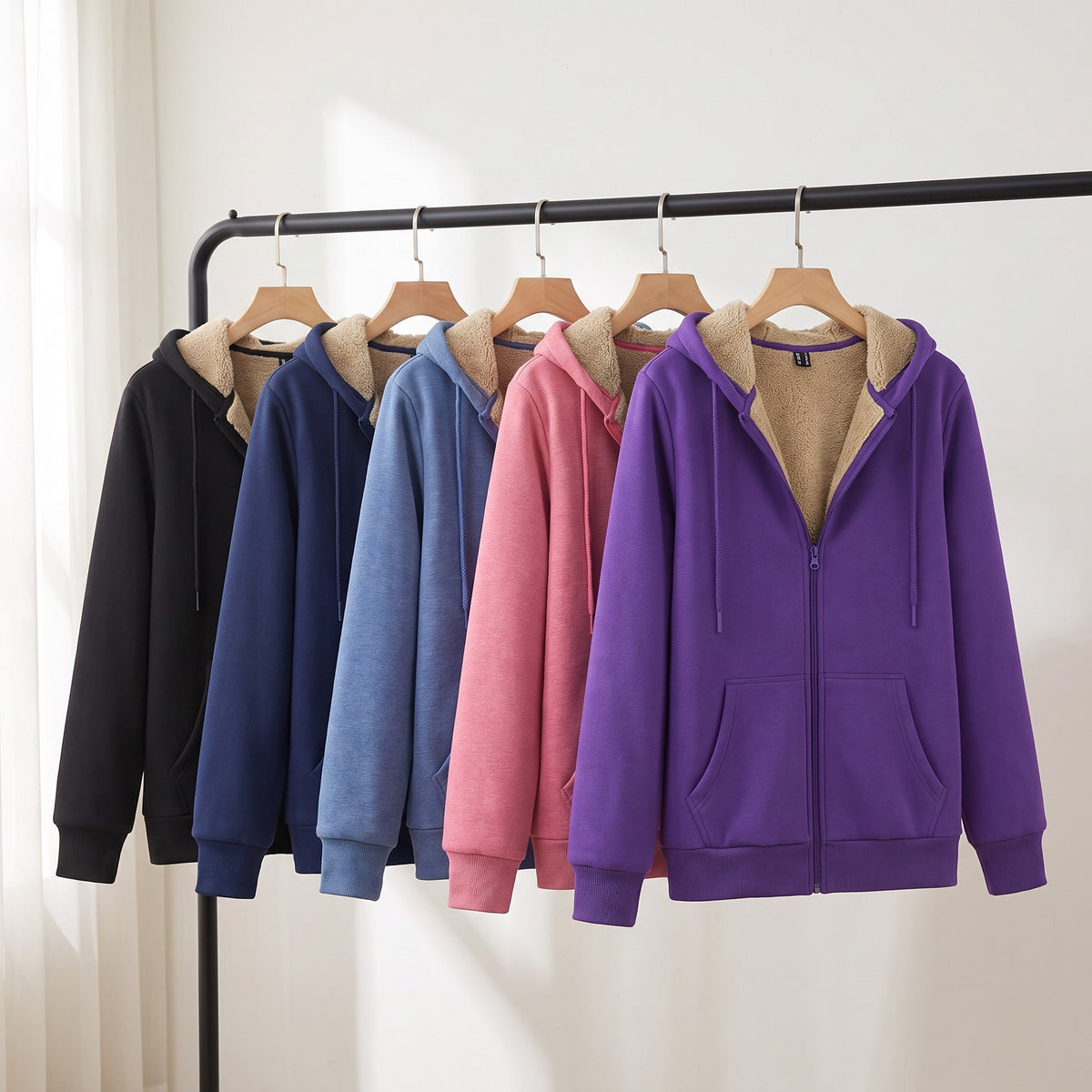 Sherpa lined zip up hoodie in Black, Navy, Grey Blue, Pink and Purple on a clothing rail