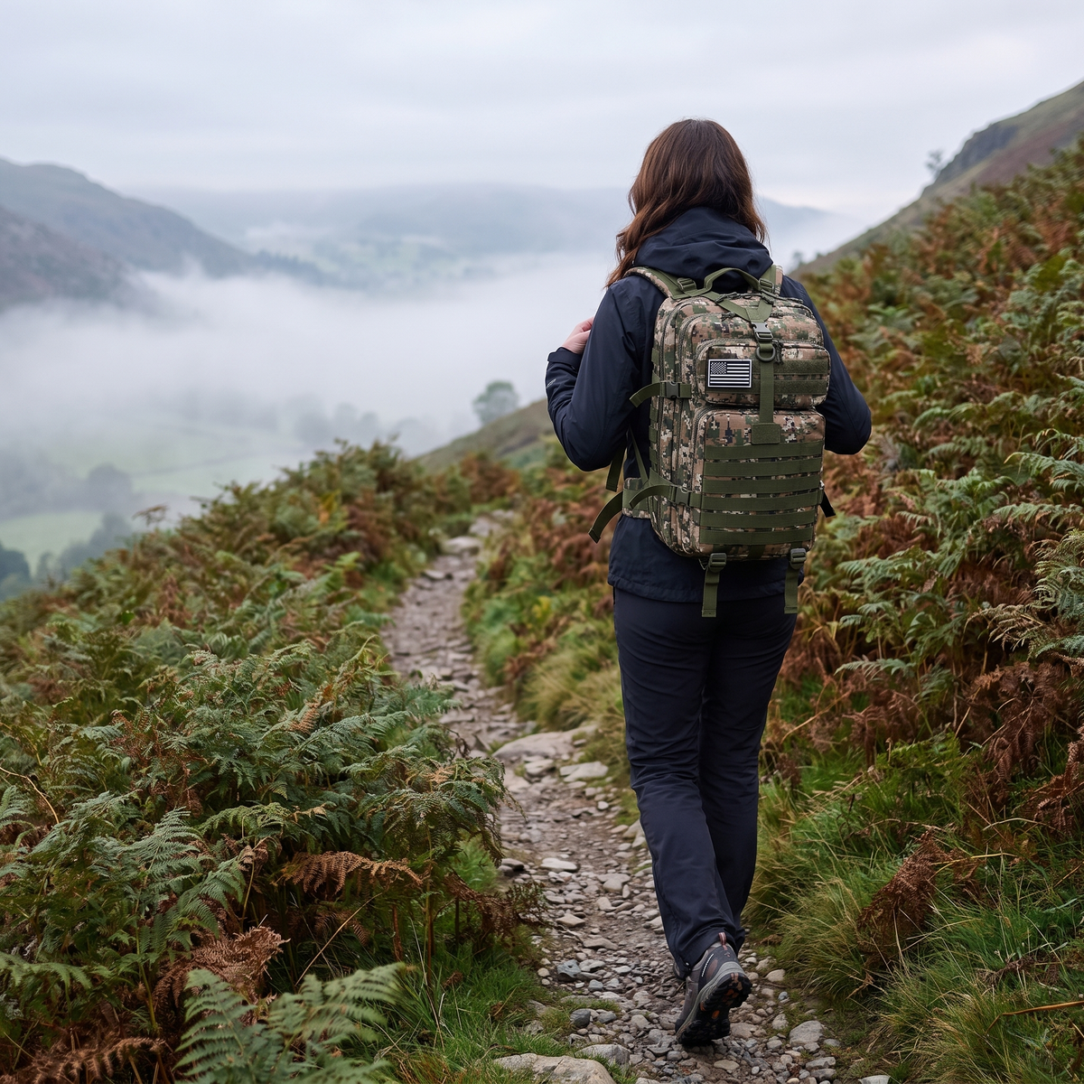 Walker wearing the 50L tactical backpack on a Lake District fell path