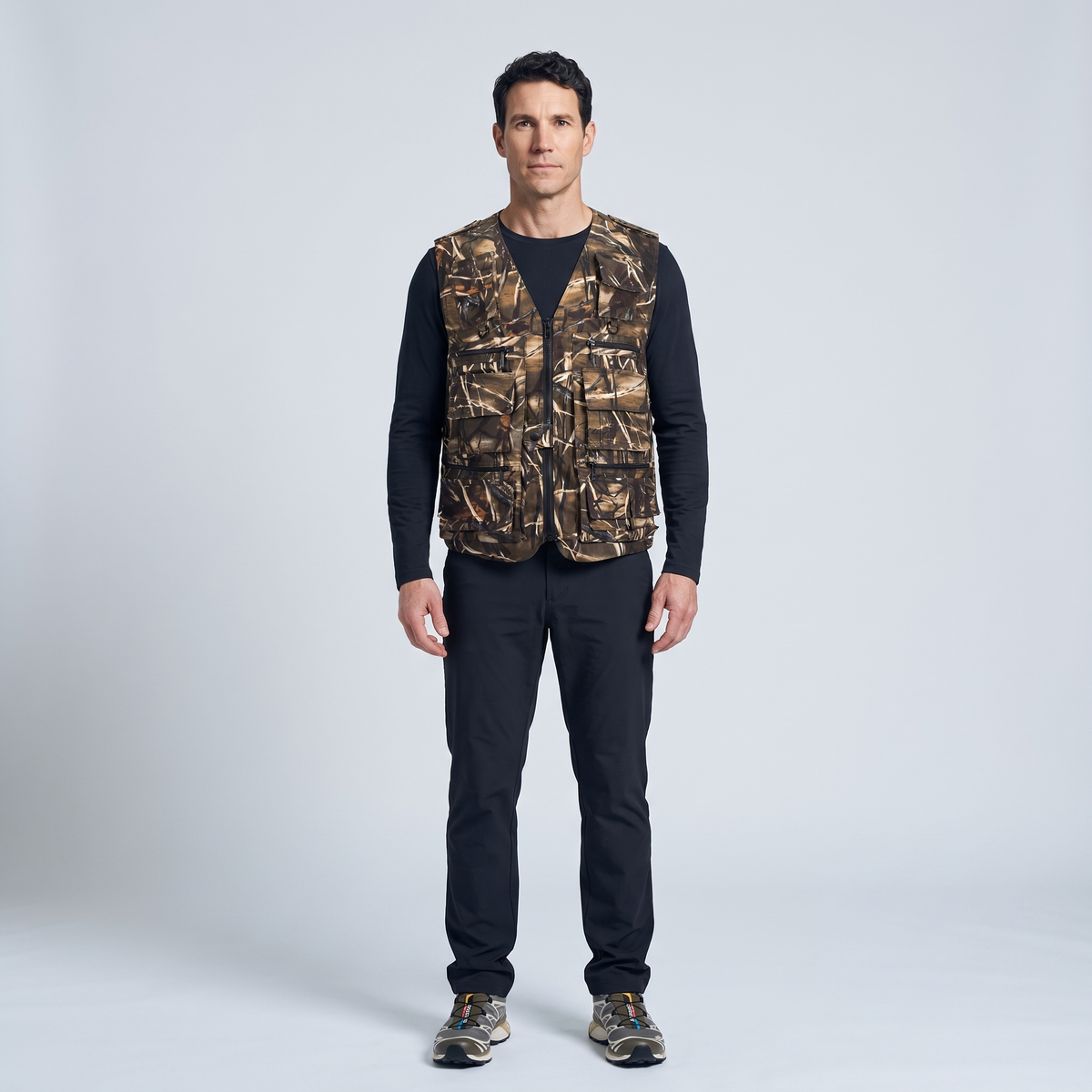 Man wearing the camo utility vest, full length studio shot