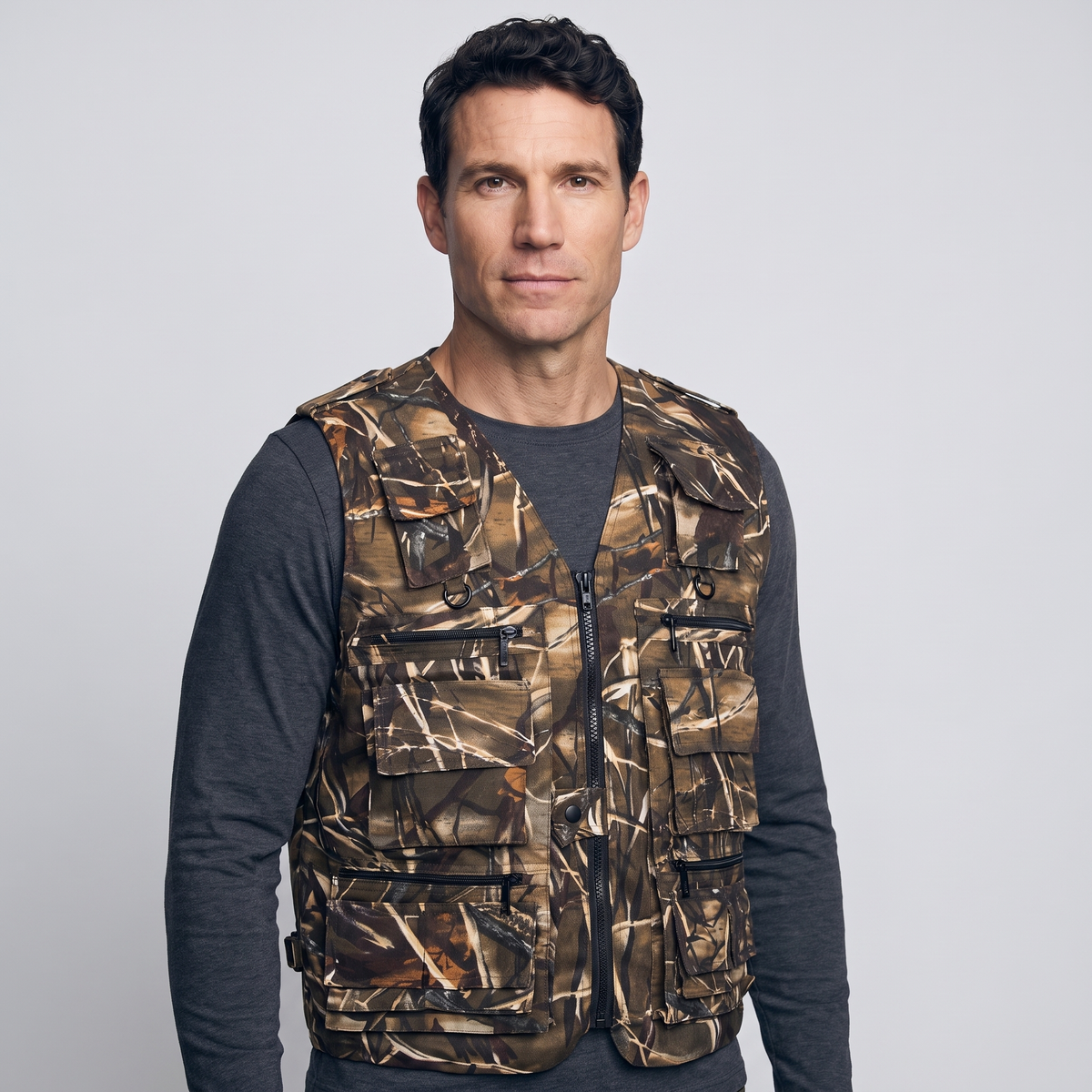 Three-quarter view of the camo utility vest worn over a long-sleeve top