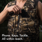 Hand sliding a phone into the zipped chest pocket of the utility vest