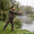 Angler casting on a British riverbank wearing the camo fishing vest