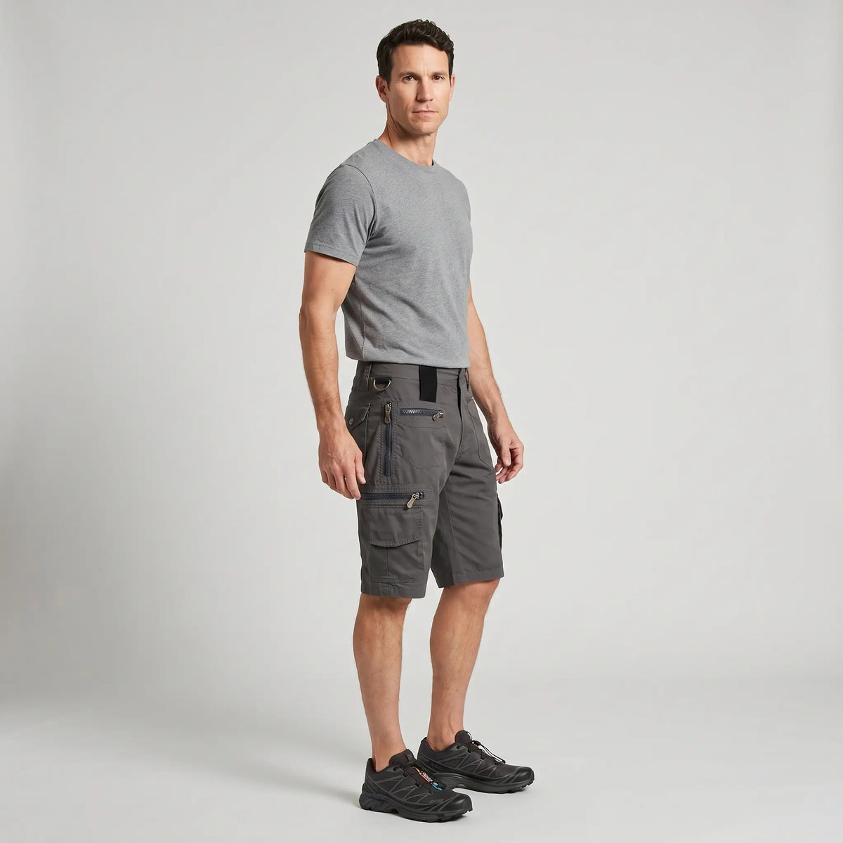 Man wearing the grey cargo shorts with a plain t-shirt and trail shoes