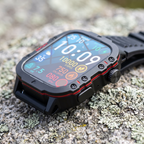 Close-up of the smart watch case with exposed bezel screws, crown and red side accents