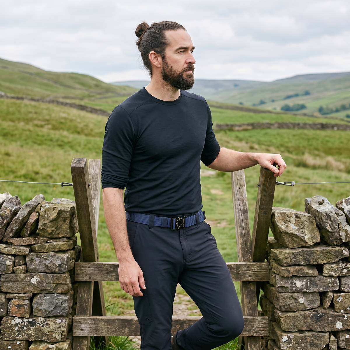 Man by a stile in the Yorkshire Dales wearing the Terrabound tactical belt in Blue
