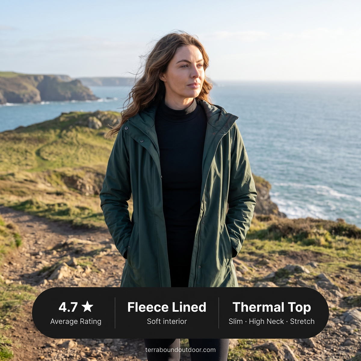 Woman in a black thermal top under an open jacket on a Cornish coast path