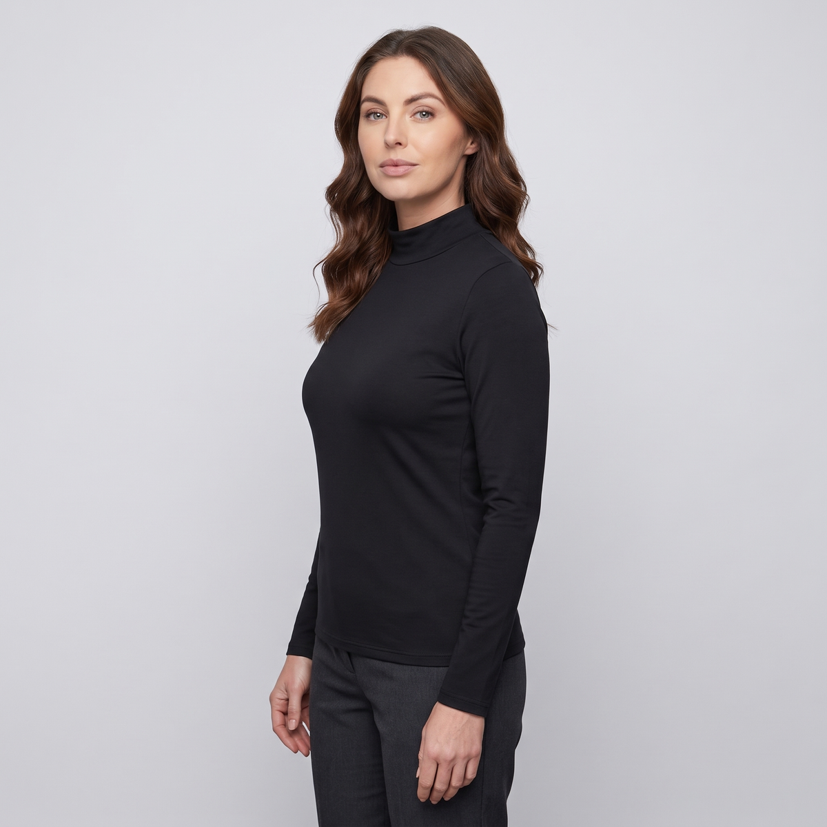Woman wearing the black women's thermal top, three-quarter side view