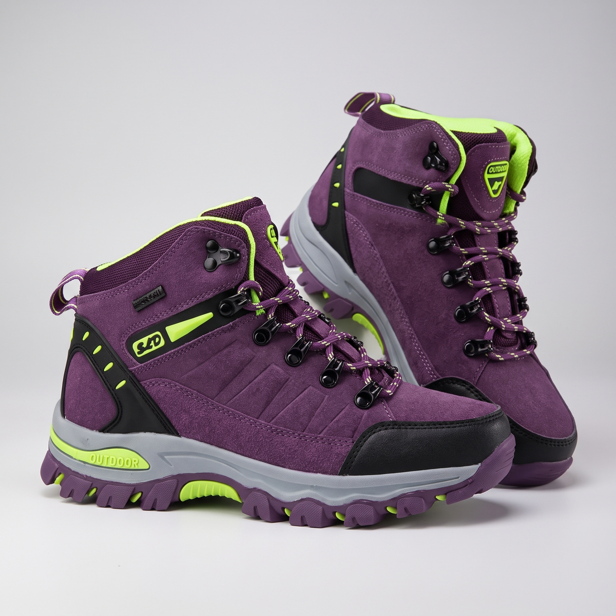 Women's walking boots in purple with lime trim, mid-cut lace-up pair
