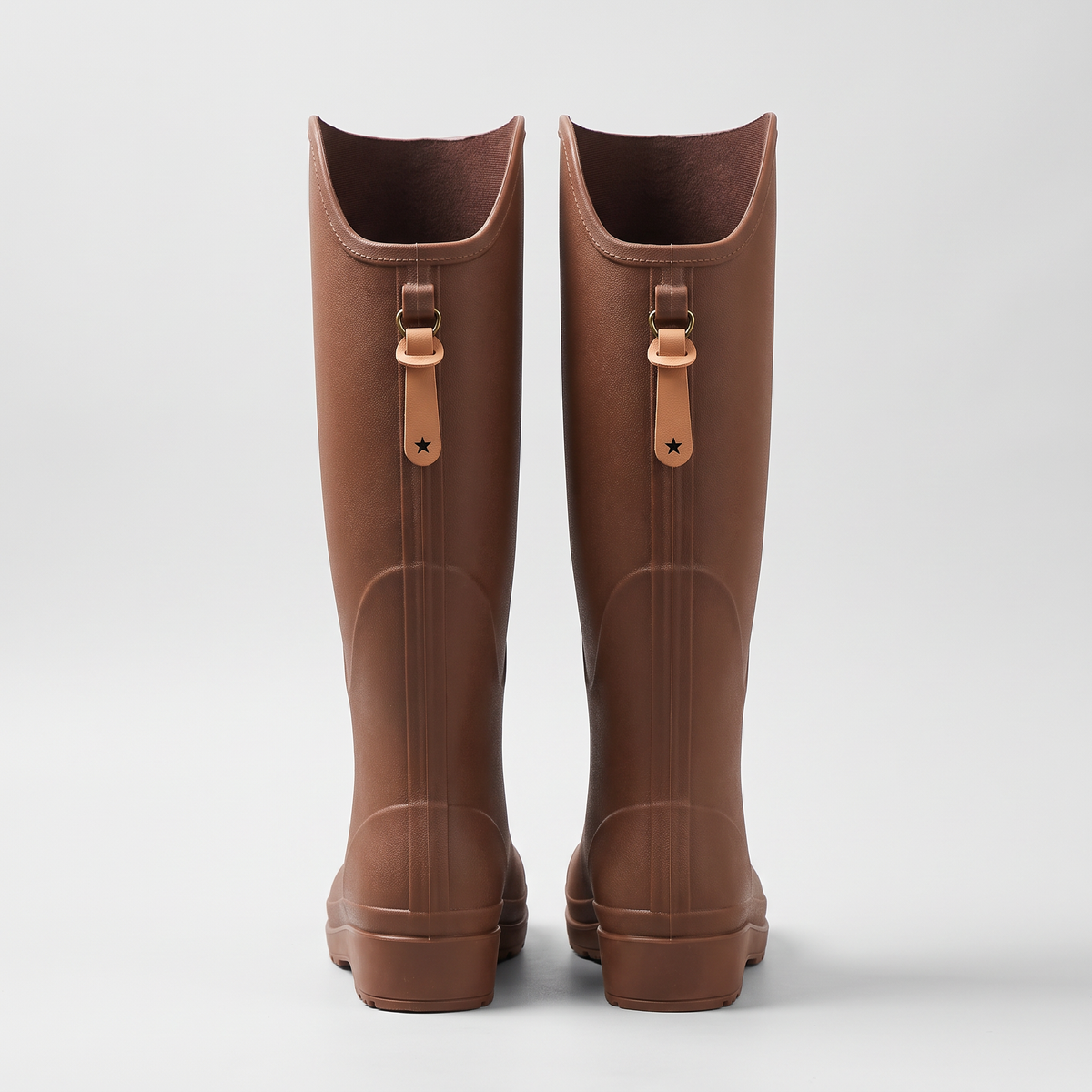 Women's knee high wellies in Brown from the back, showing the pull tabs