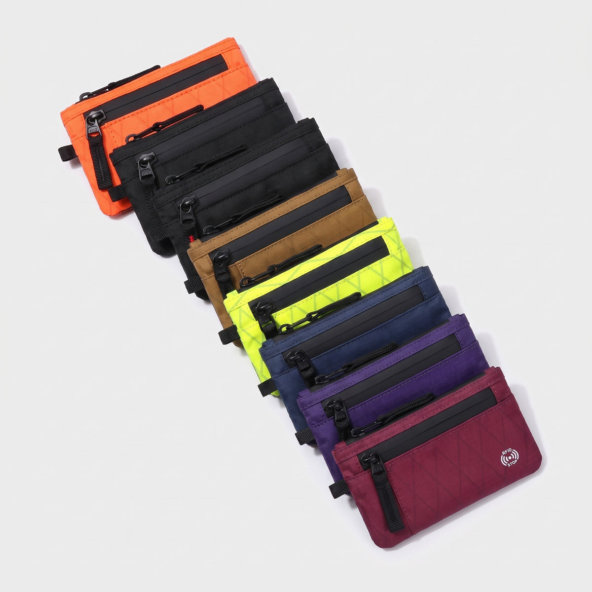 Zip card holder in eight colours fanned out: orange, black, black red, tan, lime, navy, purple, raspberry