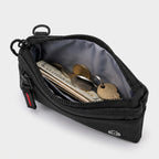Main zip pocket open showing folded notes, coins and a key inside