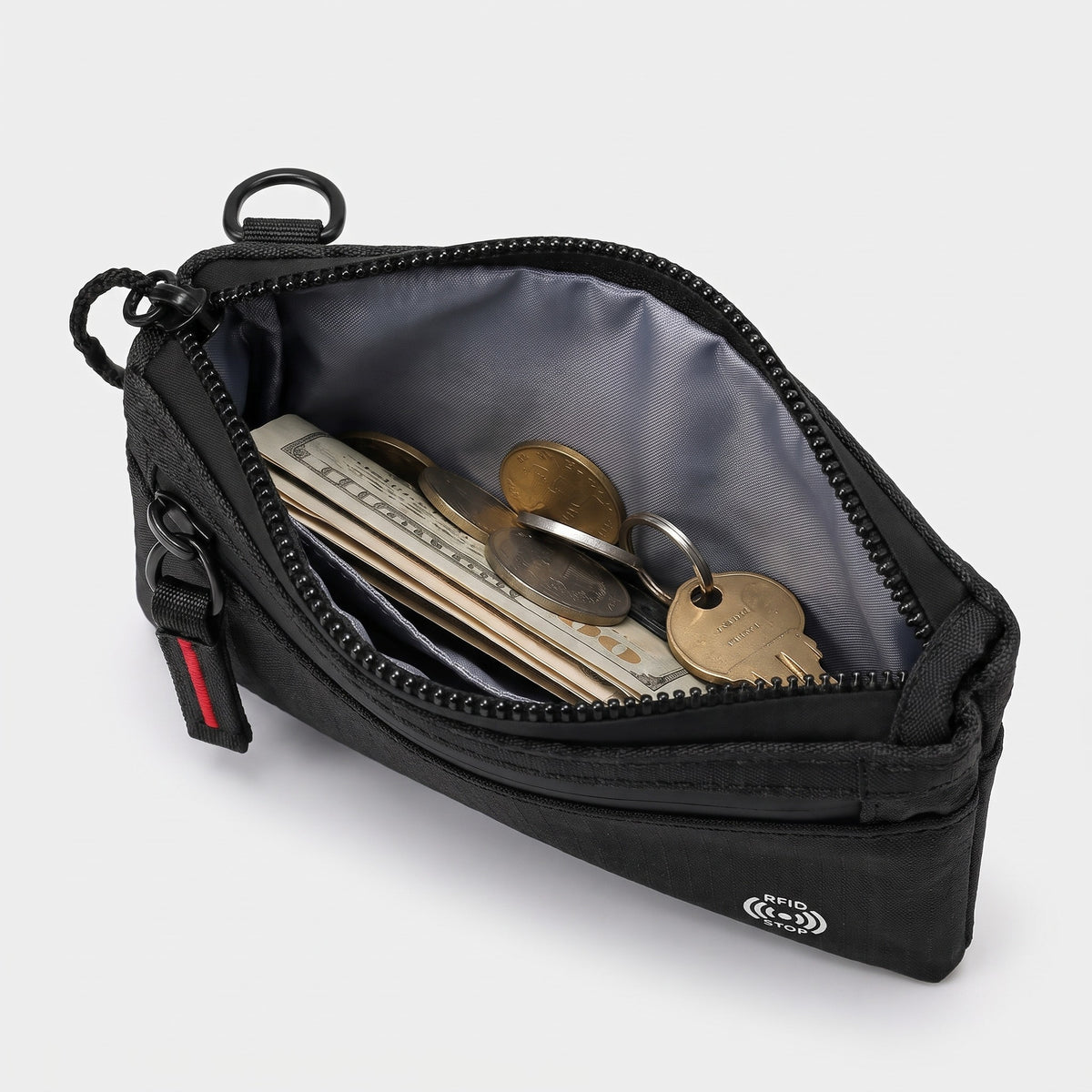 Main zip pocket open showing folded notes, coins and a key inside