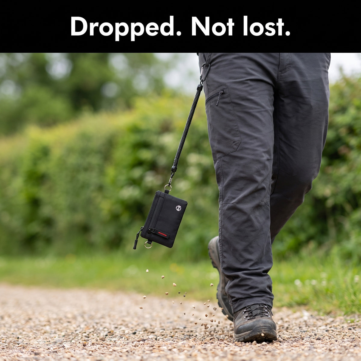 Zip card holder caught by its coiled tether cord after slipping from a walker's pocket