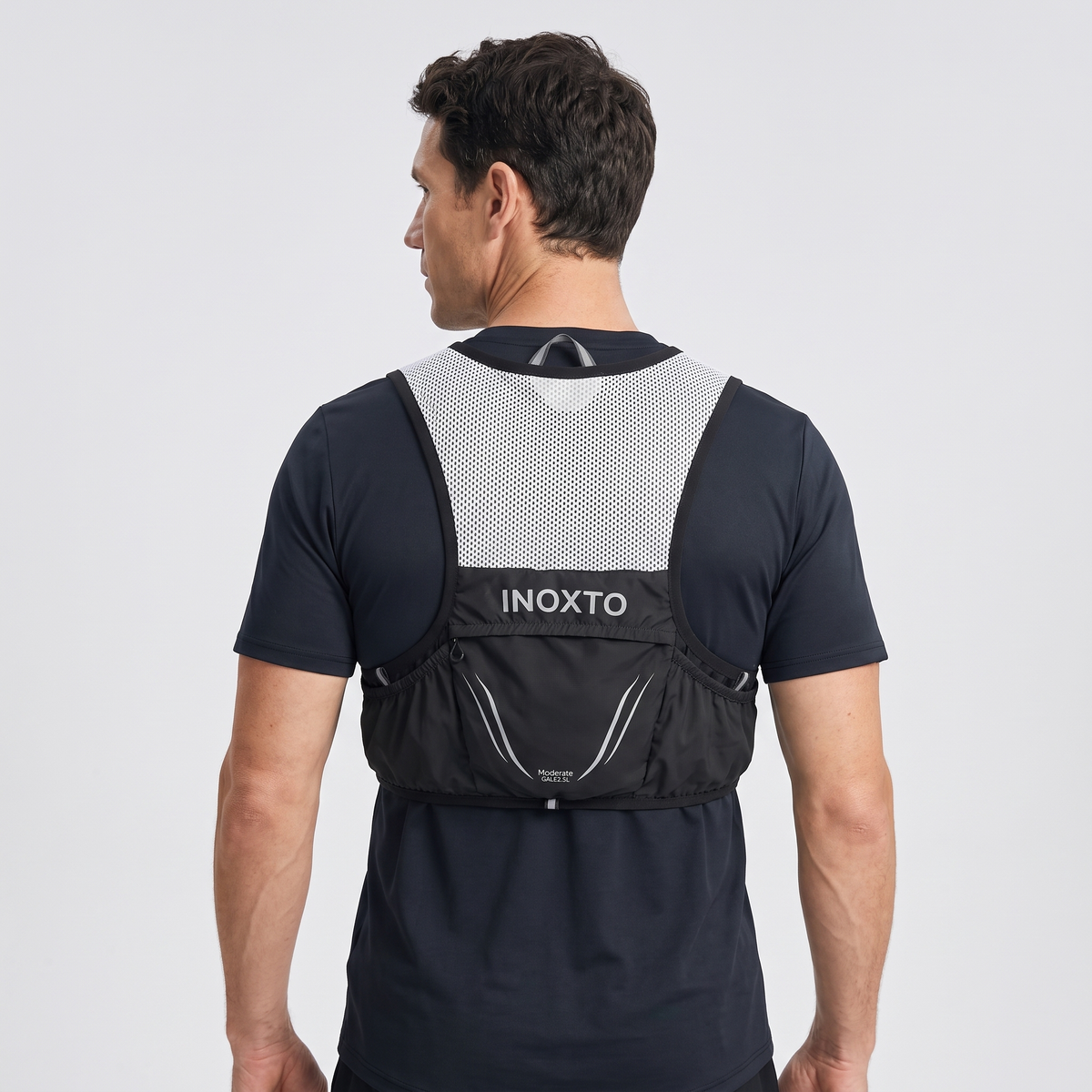 Back view of a man wearing the Terrabound trail running vest in Black showing the mesh back