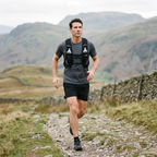 Man running a fell path in the Lake District wearing the Terrabound trail running vest