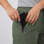 Hand sliding a phone into the zip hip pocket of the Terrabound women's cargo trousers
