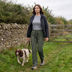 Woman walking a spaniel along a country path wearing the Terrabound women's cargo trousers